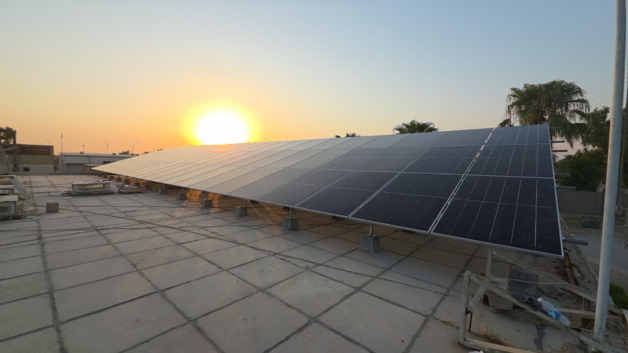 Sunset over the solar array at the General Company for Food Stuff Trading site in Al-Taji